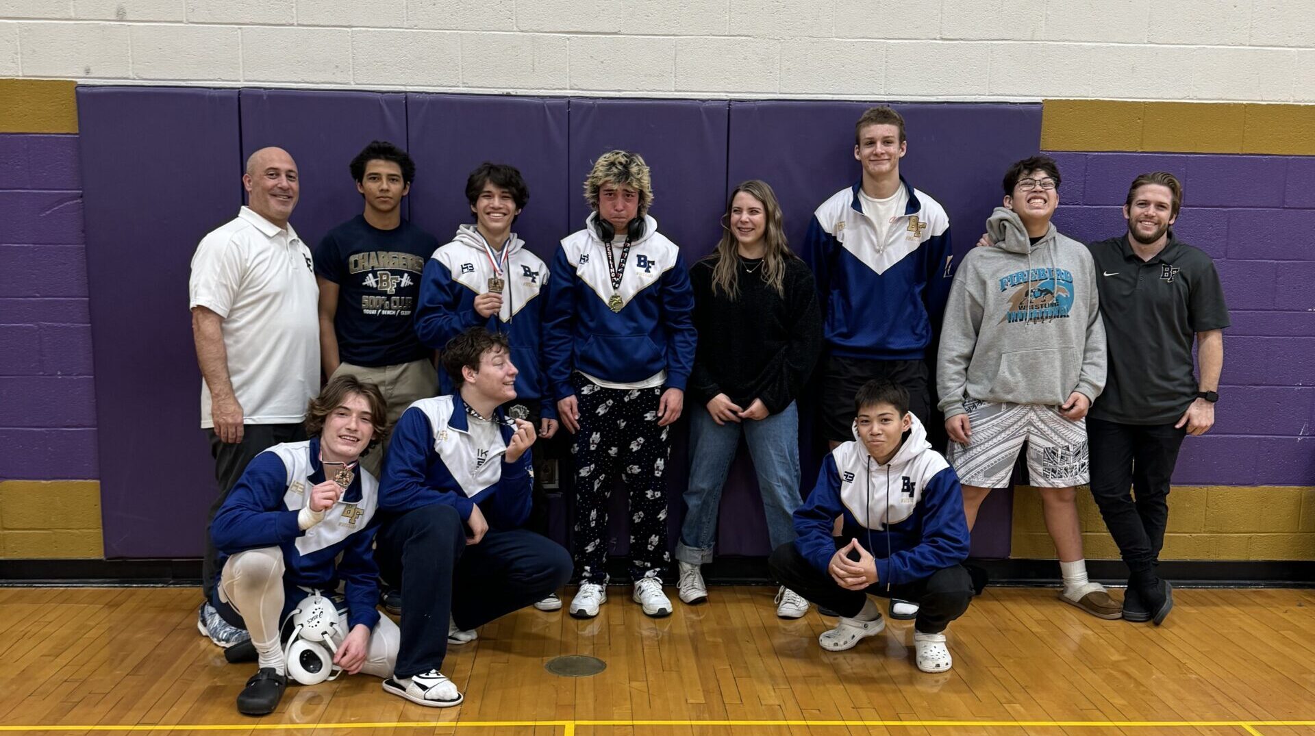 Benjamin Franklin High School's wrestling coach, Hayes Rollins (far right), was named as the Arizon...